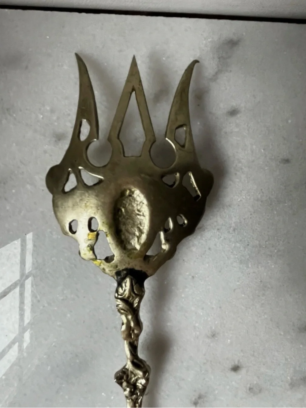 vintage Italian serving utensils are an ornate brass fork and spoon set